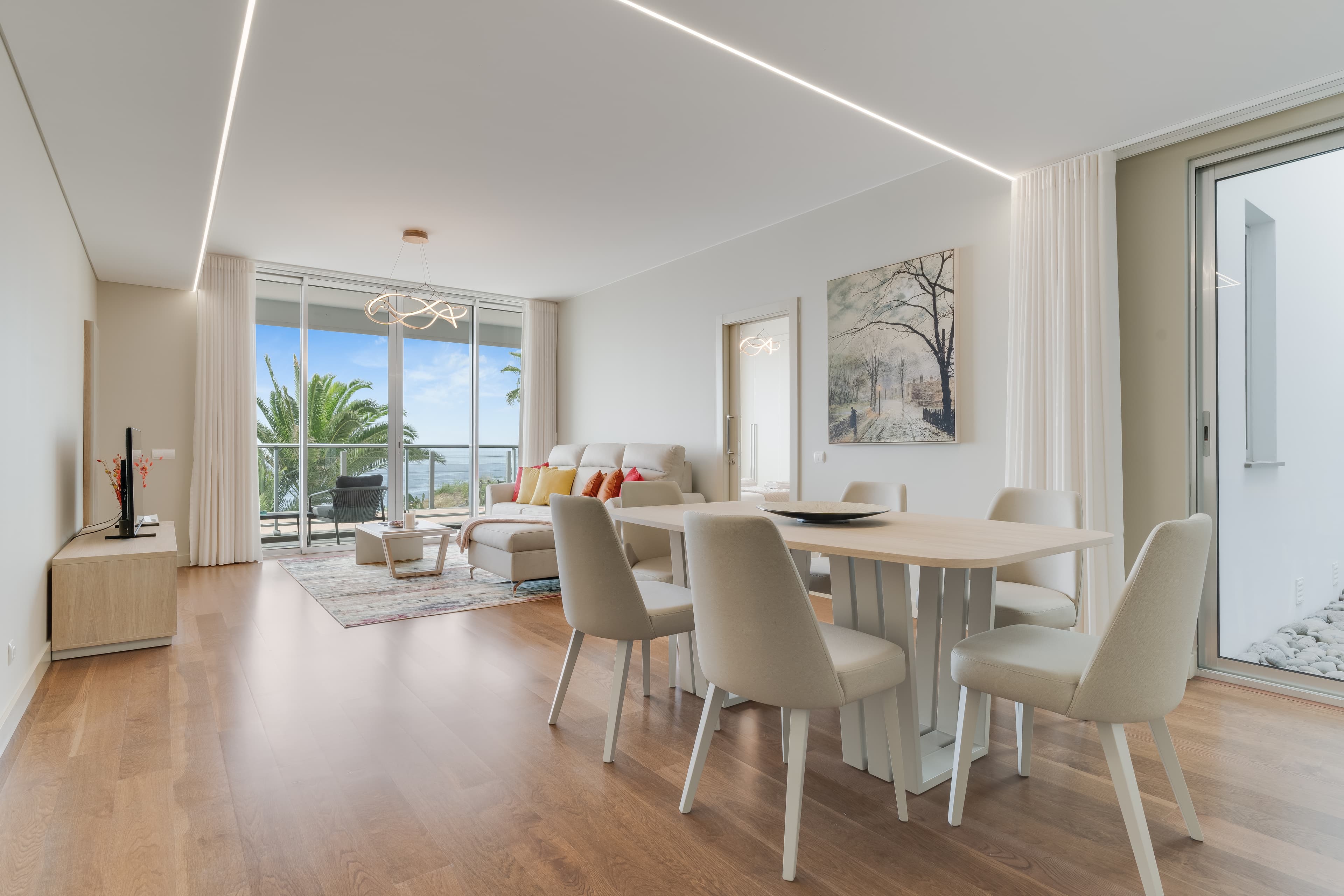 Bright modern living and dining room with ocean view